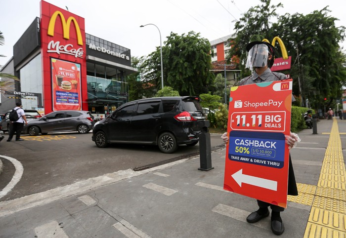 Konsumen membayar menggunakan fitur scan QR Code untuk mendapatkan Cashback 50% dan Diskon 50.000 dari ShopeePay di drive thru gerai McDonald’s.