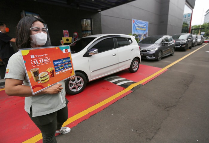 Konsumen membayar menggunakan fitur scan QR Code untuk mendapatkan Cashback 50% dan Diskon 50.000 dari ShopeePay di drive thru gerai McDonald’s.