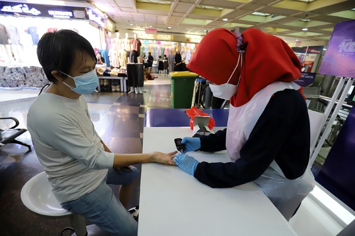 Sejumlah pedagang melakukan pengecekan gula darah di Pasar Tanah Abang, Jakarta, Kamis (18/11/2021).