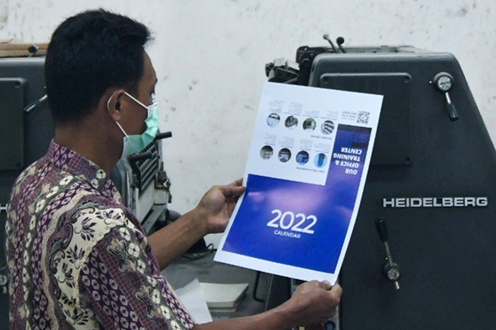 Pekerja saat menyelesaikan pembuatan kalender tahun 2022 di Jakarta Pusat, Senin (6/12/2021).