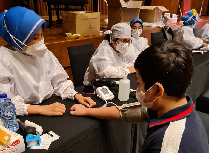 Petugas medis melakukan vaksinasi kepada seorang anak di Jakarta, Kamis (23/12/2021).