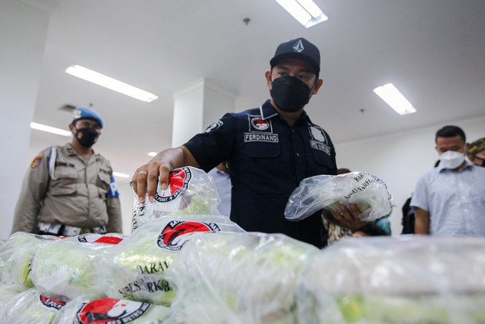 Petugas merapihkan barang bukti narkotika jenis sabu usai menggelar rilis akhir tahun di Polres Metro Jakarta Pusat, Jumat (31/12/2021).