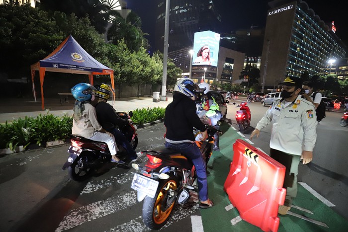 Petugas gabungan menutup akses jalan menuju Bundaran Hotel Indonesia dari Jalan Imam Bonjol, Jakarta, Jumat (31/12/2021).