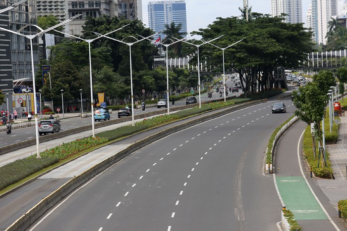 Sejumlah kendaraan melintasi di Jalan Sudirman, Jakarta, Sabtu (1/1/2022).