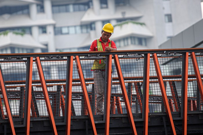 Pekerja menyelesaikan proyek jembatan penyebrangan orang (JPO) Pinisi di kawasan Sudirman, Jakarta, Rabu (5/1/2022).