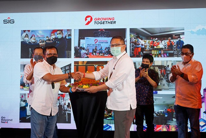 Komisaris Utama SIG, Rudiantara (Kanan) menyerahkan potongan tumpeng kepada Direktur Utama SIG, Donny Arsal pada peringatan HUT ke-9 SIG di Jakarta.