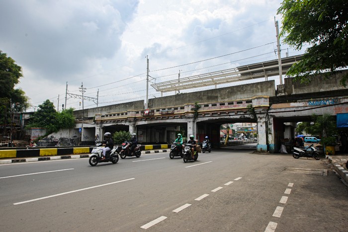 Warga berjalan diatas jembatan kereta api di kawasan Matraman, Jakarta Timur, Kamis (13/1/2022).