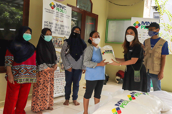 Relawan MNC Peduli saat meberikan bantuan berupa beras kepada warga di kawasan bantaran sungai Ciliwung, Serengseng Sawah, Jagakarasa.