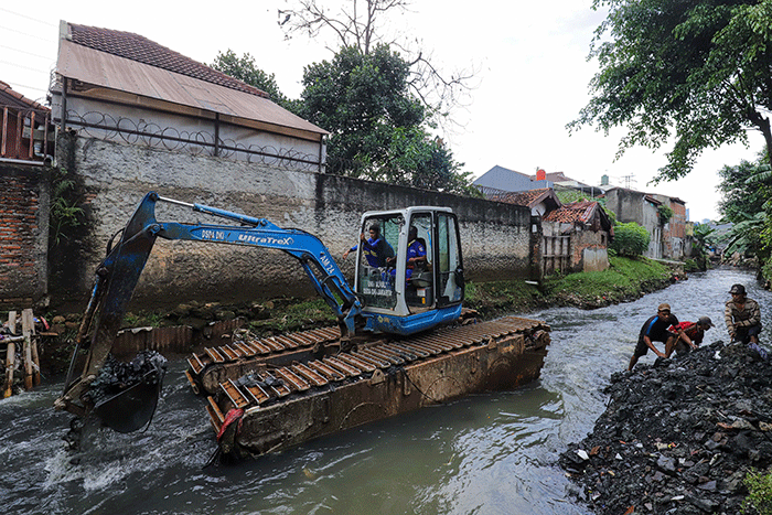 Warga melihat proses pengerukan Kali Mampang di Pondok Jaya, Jakarta Selatan, Sabtu (19/2/2022).
