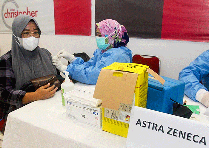 Tenaga Kesehatan menyuntikan vaksin booster Pfizer dan Astrazeneca ke warga untuk mencegah penyebaran Covid-19 di Depok, Jawa Barat, Senin (21/2/2022).