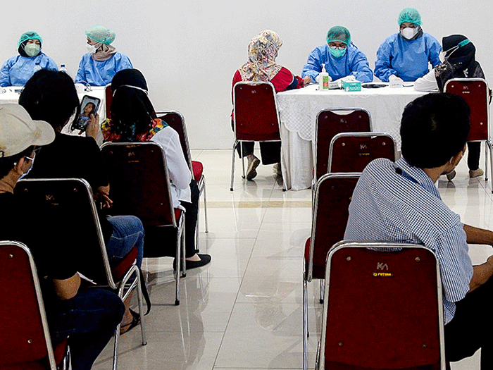 Tenaga Kesehatan menyuntikan vaksin booster Pfizer dan Astrazeneca ke warga untuk mencegah penyebaran Covid-19 di Depok, Jawa Barat, Senin (21/2/2022).