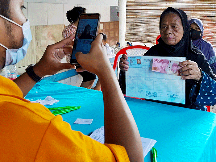 Warga saat mengambil Bantuan Pangan Non Tunai yang sekarang cair berupa uang tunai di Jakarta Selatan, Minggu (27/2/2022).