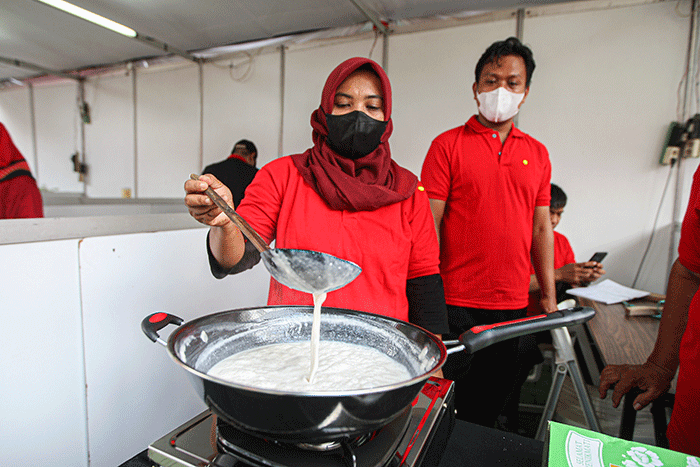 Kader Partai Demokrasi Indonesia Perjuangan (PDIP) menunjukan hasil olahan minyak kelapa saat acara demo masak tanpa minyak goreng.