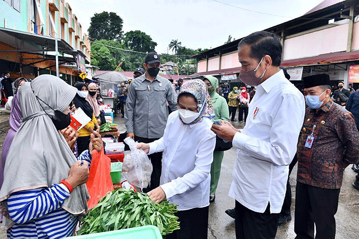 Presiden Joko Widodo didampingi Ibu Negara Iriana Joko Widodo berbincang dengan pedagang makanan saat kunjungan kerja ke Pasar Modern Angso Duo di Jambi.