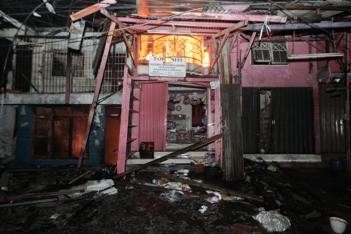 Petugas pemadam kebakaran berusaha memadamkan kobaran api yang membakar kios dan rumah warga di kawasan Pasar Gembrong, Jatinegara, Jakarta Timur.