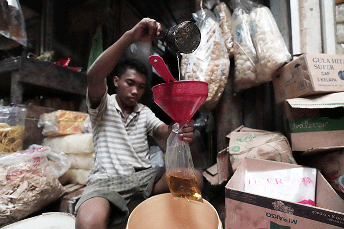 Pedagang mengemas minyak goreng curah di Pasar Kecapi, Kota Bekasi, Jawa Barat, Rabu (18/5/2022).