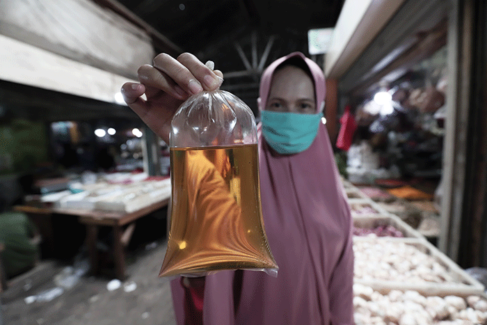 Warga menunjukkan minyak goreng curah di Pasar Kecapi, Kota Bekasi, Jawa Barat, Sabtu (21/5/2022).