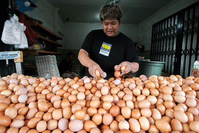 Pedagang telur ayam saat melayani pembeli di kawasan Kampung Makasar, Jakarta Timur, Minggu (29/5/2022).