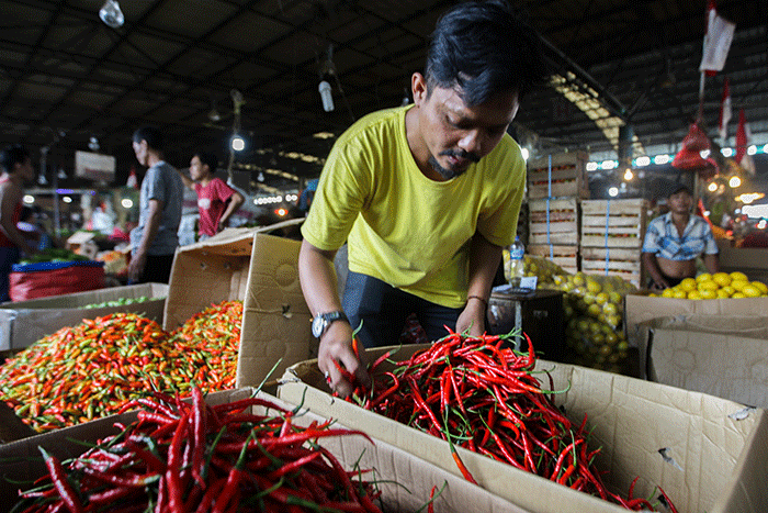 Pedagang saat merapikan cabai merah keriting di Pasar Induk Kramat Jati, Jakarta Timur, Jumat (10/6/2022).