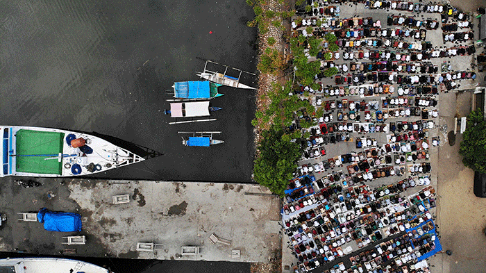 Foto udara sejumlah umat muslim menunaikan ibadah salat Idul Adha 1443 H di Pelabuhan Paotere Makassar, Minggu (10/7/2022).
