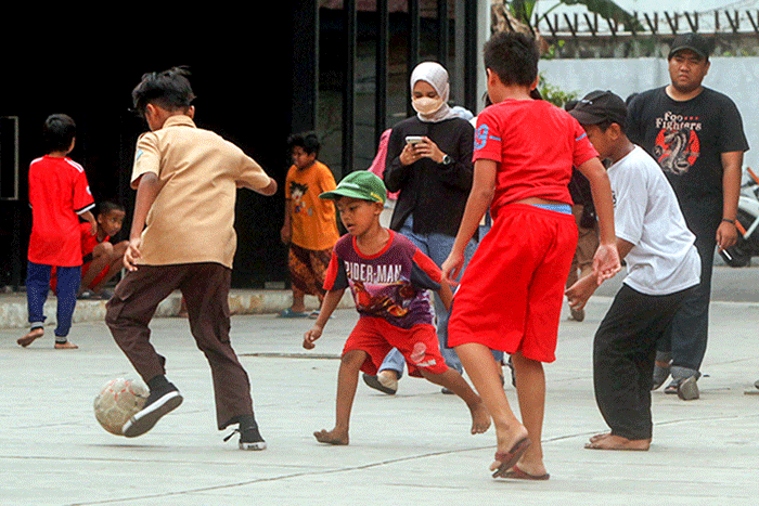 Anak-anak saat bermain bola di kawasan Taman Ismail Marzuki, Jakarta, Rabu, (13/7/2022).