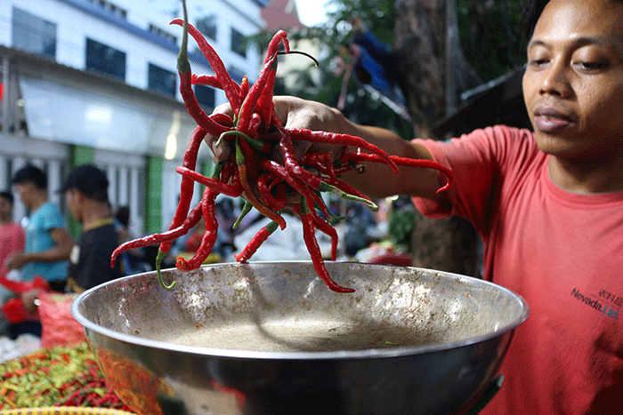 Pedagang cabai melayani pembeli di Pasar Inpres Serdang Kemayoran, Jakarta, Kamis (14/7/2022).