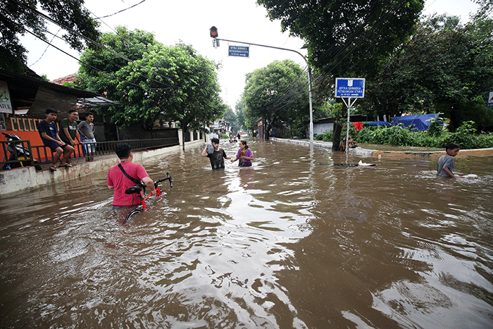 Anak-anak bermain banjir yang menggenangi Jalan Swadarma Raya, Petukangan, Jakarta, Sabtu (5/11/2022).