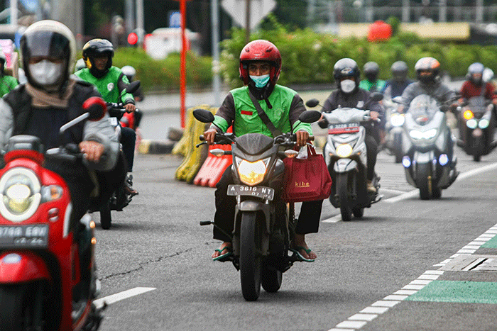 Driver Gojek saat melintas di kawasan Jakarta, Jumat (18/11/2022).