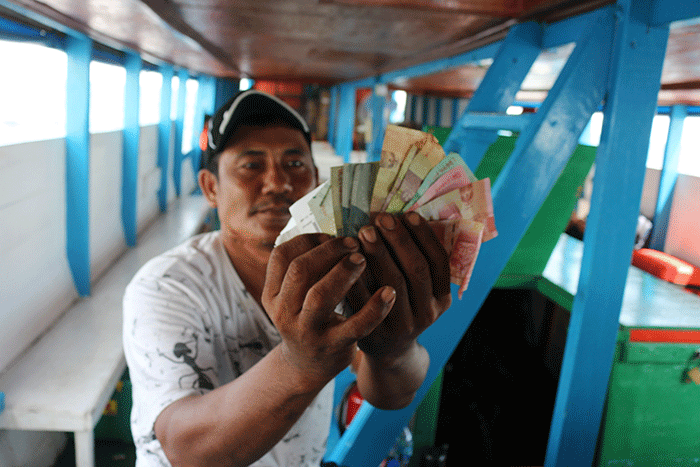 Anak Buah Kapal (ABK) angkutan transportasi laut kapal tradisional menunjukkan penghasilannya di Jakarta, Sabtu (19/11/2022).