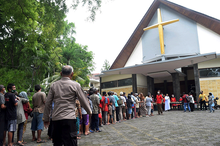 Ibu-ibu relawan Piring Kasih berbagi makan siang gratis kepada masyarakat di pelataran Gereja St Theresia Bongsari Semarang, Jawa Tengah, Kamis (22/12/2022).