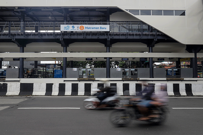 Pengendara melintas di Halte Transjakarta Matraman Baru, Jakarta Timur, Senin (26/12/2022).