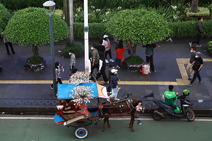Suasana pusat perkantoran setelah pemerintah mengumumkan pencabutan status PPKM di kawasan Jalan MH. Thamrin, Jakarta, Jumat (30/12/2022).