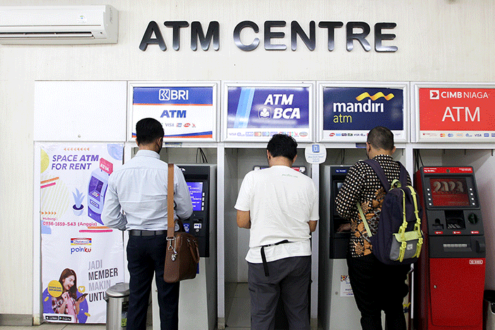 Nasabah melakukan transaksi di Anjungan Tunai Mandiri (ATM) kawasan Jakarta Selatan, Senin (9/1/2023).