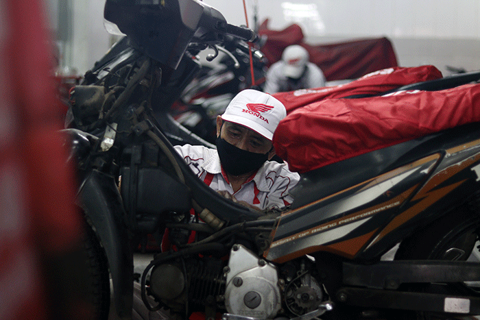 Teknisi sedang menservice sepeda motor di bengkel Astra Honda Motor, Jalan AP Pettarani, Makassar, Selasa  (14/2/2023).