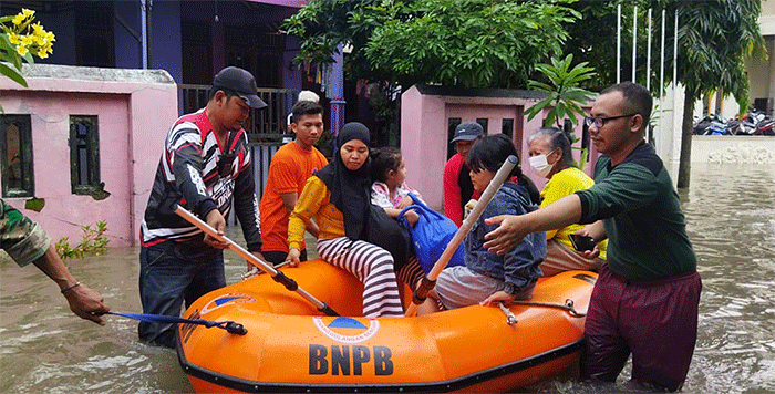 Tim BPBD Kota Surakarta mengevakuasi warga menggunakan perahu karet akibat banjir di wilayah Kota Surakarta, Jawa Tengah, Jumat (17/2/2023).