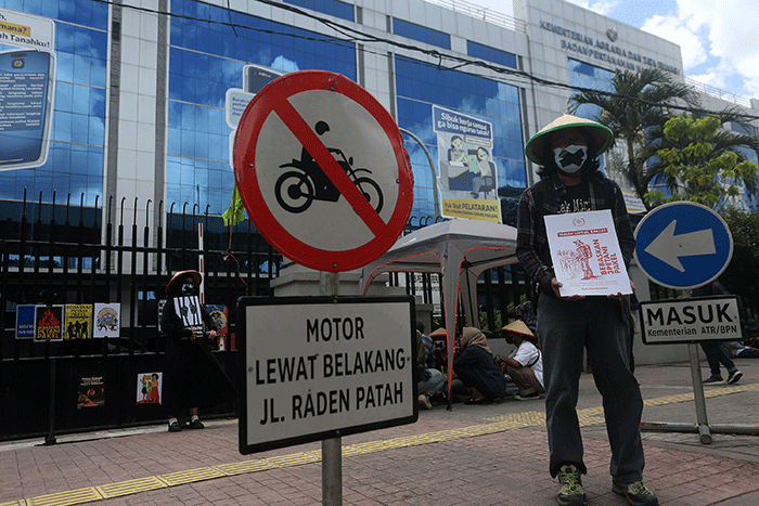 Aktivis Gerakan Rakyat untuk Kedaulatan Agraria membawa poster saat aksi mogok makan di depan Kantor Kementerian ATR/BPN, Jakarta, Senin (20/2/2023).