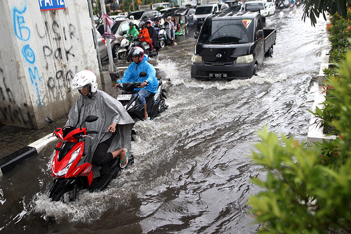 Sejumlah kendaraan bermotor menerobos banjir di Jalan AP Pettarani, Makassar, Senin (10/4/2023).