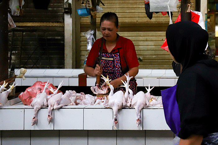 Pedagang ayam potong saat menunggu pembeli di pasar tradisional di kawasan Jakarta Selatan, Senin (17/4/2023).