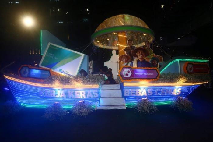 Perahu warna-warni BPJS Ketenagakerjaan tampil memukau saat mengikuti light parade HUT ke-730 Kota Surabaya, Sabtu (27/5/2023).