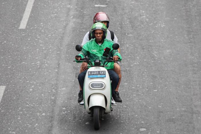 Pengendara ojek online melintas di kawasan Sudirman, Jakarta, Senin (23/10/2023).