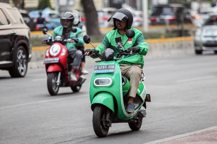 Pengendara ojek online melintas di kawasan Sudirman, Jakarta, Senin (23/10/2023).